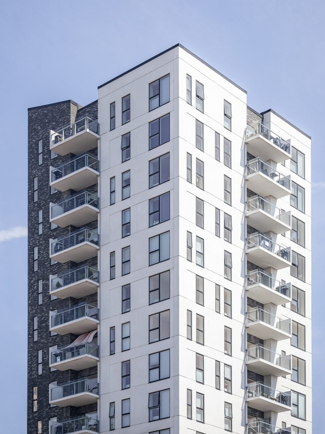 A vertical shot of a white building under the clear sky